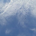 airplane in blue sky white cloud high from afar Royalty Free Stock Photo