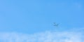 Airplane on blue sky and white clouds. Commercial airline flying on blue sky. Travel flight for vacation. Aviation transport Royalty Free Stock Photo