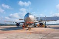 Airplane with boarding stairs, waiting for boarding passengers and baggage before the flight, airport trip Royalty Free Stock Photo