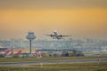 Airplane after boarding takeoff near the control tower heading to its destination Royalty Free Stock Photo