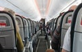 Airplane cabin aisle with rear view and seats Royalty Free Stock Photo