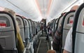 Airplane cabin aisle with rear view and seats