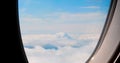 Airplane calmly flies above clouds, view from window. serenity high-altitude travel. tranquil scene above clouds Royalty Free Stock Photo