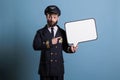Airplane pilot pointing at white blank speech bubble
