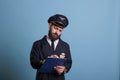 Airplane captain holding clipboard