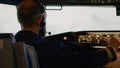 Airplane captain pushing buttons to fix altitude and longitude