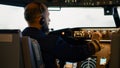 Airplane captain pushing buttons to fix altitude and longitude