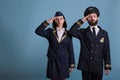 Airplane captain and stewardess saluting portrait