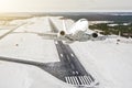 Airplane is climb flight level high view in the air, against the background of the winter airport of the runway, city, snow, fores