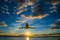 The airplane climbs, flying over the sea towards the sun at sunset Royalty Free Stock Photo