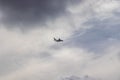 Airplane in the cloudy sky - Passenger Airliner aircraft, London, England Royalty Free Stock Photo