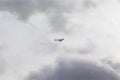 Airplane in the cloudy sky - Passenger Airliner aircraft, London, England Royalty Free Stock Photo