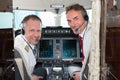 Airplane cockpit pilot crew smiling at camera Royalty Free Stock Photo