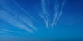 Airplane contrail against blue sky. Jet plane condensation trail, clouds lines