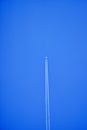 An airplane contrail in a clear blue sky. Royalty Free Stock Photo