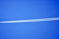An airplane contrail in a clear blue sky. Royalty Free Stock Photo