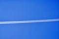 An airplane contrail in a clear blue sky. Royalty Free Stock Photo