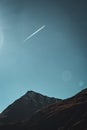 An airplane contrail in a perfect blue sky