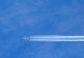 Airplane with contrails in clear blue sky, Cruising altitude