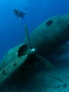 Diver exploring wreck of aircraft Royalty Free Stock Photo