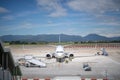 Airplane docked at the airport, pre-flight refueling and loading cargo service of airplane, preparation for take-off in gate, Royalty Free Stock Photo