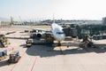 Airplane docking at airport terminal gate, loading luggage prepare to departure. Plane transit, take off operation Royalty Free Stock Photo