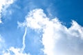 Airplane doing acrobatics in blue sky leaves a smoke. Blue sky with airport contrail clouds Royalty Free Stock Photo