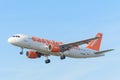 Airplane easyJet G-EZWB Airbus A320-200 is landing at Schiphol airport.