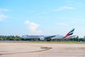 Airplane of Emirates airline is landing in Phuket international airport.