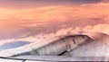 airplane engine over sunset clouds view from airplane window. Filtered image