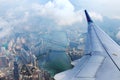 Airplane flies over Hong Kong. Passenger jet plane flying above urban scene.