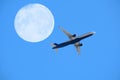 airplane flight against full moon and blue sky, aviation and travel concept