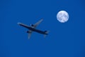 airplane flight against full moon and night sky, aviation and travel concept