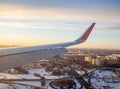 Airplane flight. Aircraft's wing and land seen through the illuminator