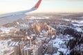 Airplane flight. Aircraft's wing and land seen through the illuminator