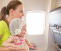 Airplane flight from inside. Woman and kid travelling together. Royalty Free Stock Photo