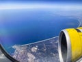 Airplane flight. Wing of an airplane flying above the clouds and sea in La Palma, Canary Islands. View from the window of the Royalty Free Stock Photo