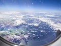 Airplane flight. Wing of an airplane flying above the clouds and sea in La Palma, Canary Islands. View from the window of the Royalty Free Stock Photo