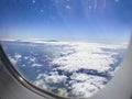 Airplane flight. Wing of an airplane flying above the clouds and sea in La Palma, Canary Islands. View from the window of the Royalty Free Stock Photo