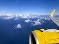 Airplane flight. Wing of an airplane flying above the clouds and sea in La Palma, Canary Islands. View from the window of the Royalty Free Stock Photo