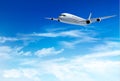 Airplane fly in the in a blue cloudy sky. Travel concept.