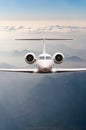 Airplane fly over clouds and Alps mountain on sunset. Front view of a big passenger or cargo aircraft, business jet Royalty Free Stock Photo