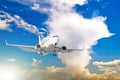 Airplane at fly on the sky with cumulus clouds sunset. Royalty Free Stock Photo