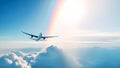 Airplane flying above amazing clouds in clear blue sky with rainbow and sun raies Royalty Free Stock Photo