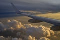 Airplane flying above the clouds against a beautiful sunset Royalty Free Stock Photo