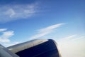 View from airplane window engine and wing flying above the clouds Royalty Free Stock Photo