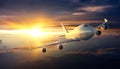 Airplane flying above clouds during sunset