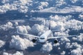 Airplane is flying above the clouds at sunset in summer Royalty Free Stock Photo