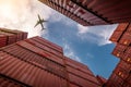 Airplane flying above container logistic. Cargo and shipping business. Container ship for import and export logistic. Logistic Royalty Free Stock Photo