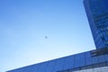 Airplane flying above glass office buildings and futuristic design Royalty Free Stock Photo